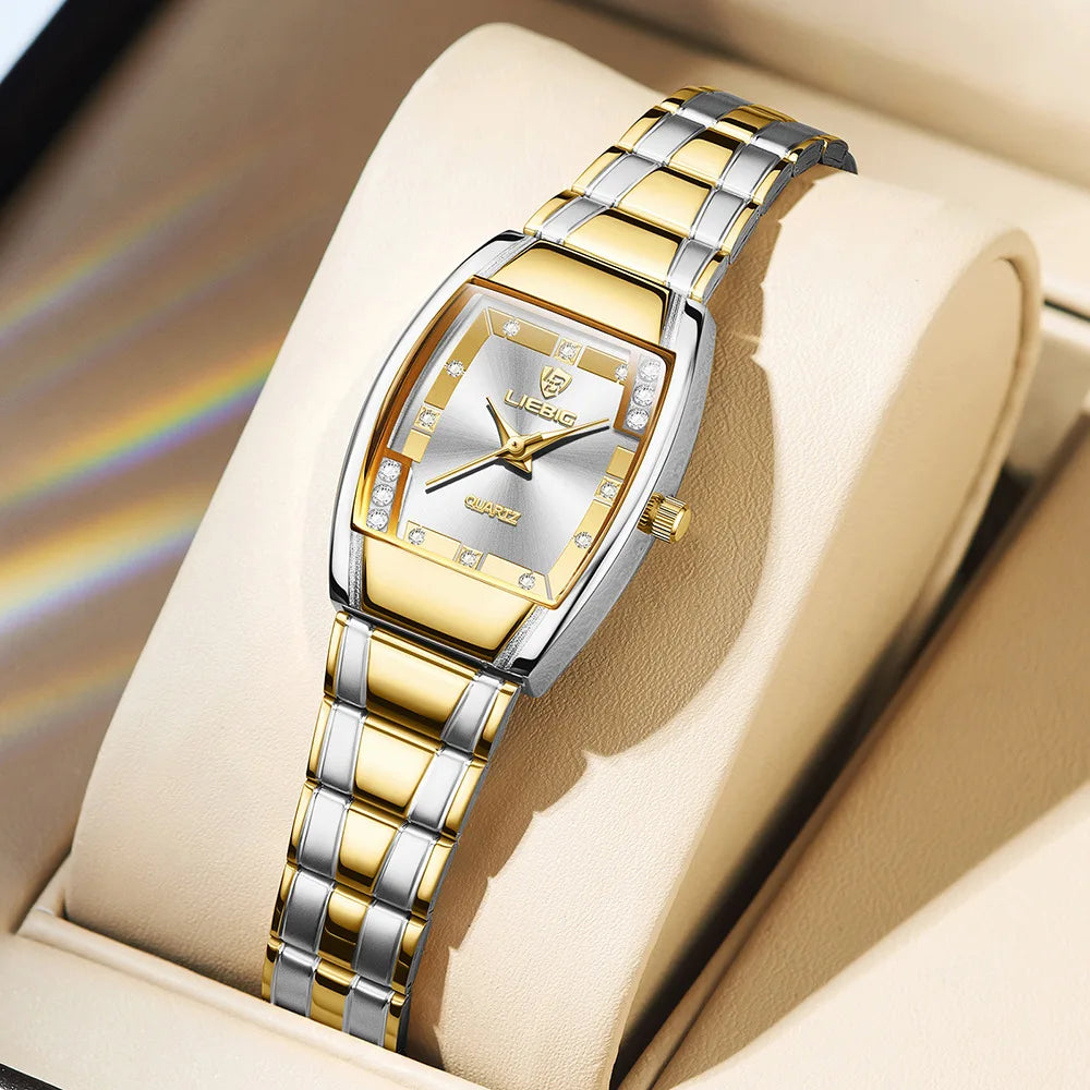A gold and silver minimalist quartz wristwatch with a metal bracelet displayed in a light-colored box.