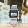 A silver Casio Alarm Chrono watch with a large numeric dial and metal bracelet displayed on a wooden surface.