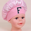 Pink A-Z letter sleep cap for kids with a black letter F