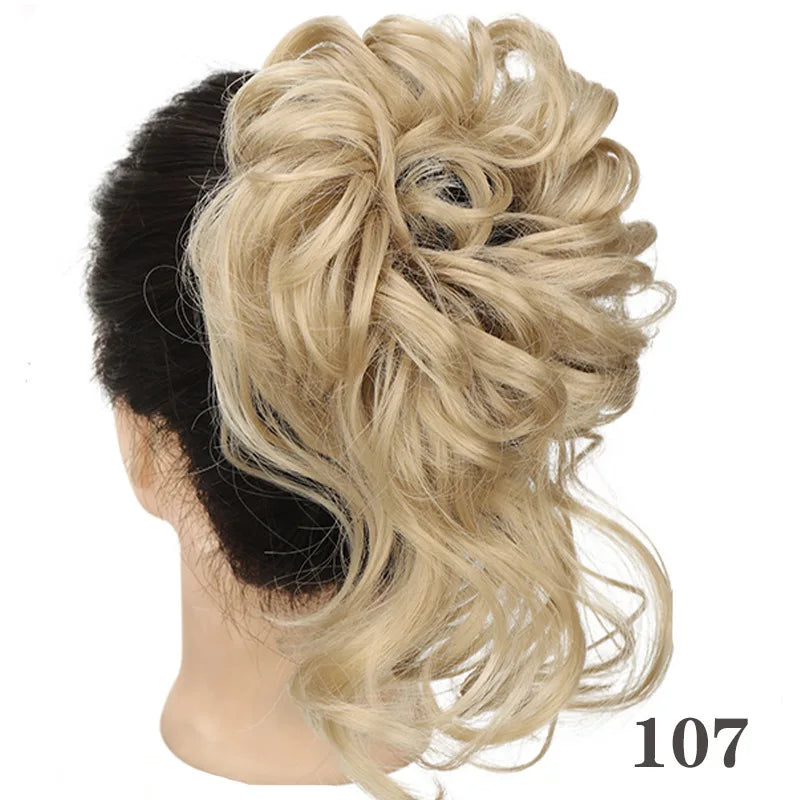 A woman's dark hair is styled into a voluminous, messy blonde bun using synthetic hairpiece.