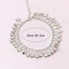 Silver bell foot chain anklet with a circular design and adjustable length markings.