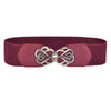 A maroon elastic belt with a decorative brass Celtic knot buckle.