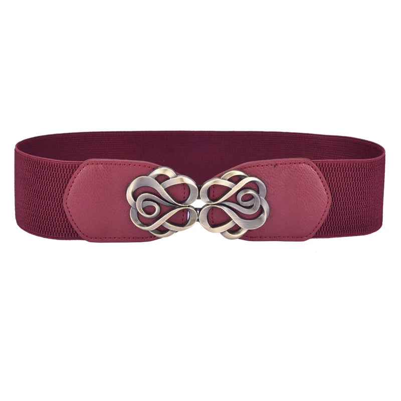 A maroon elastic belt with a decorative brass Celtic knot buckle.