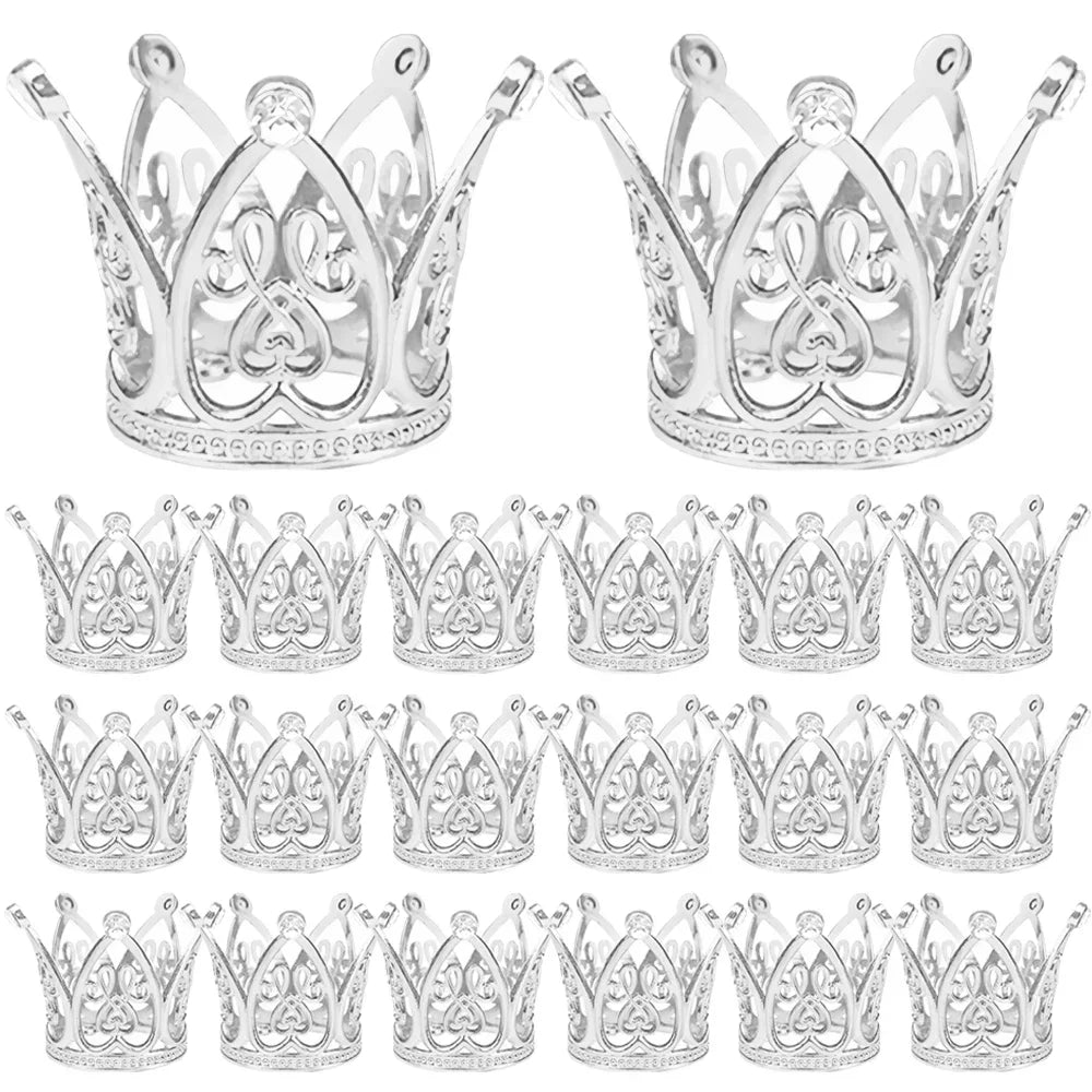 A collection of gold and silver mini crown cake toppers for parties.