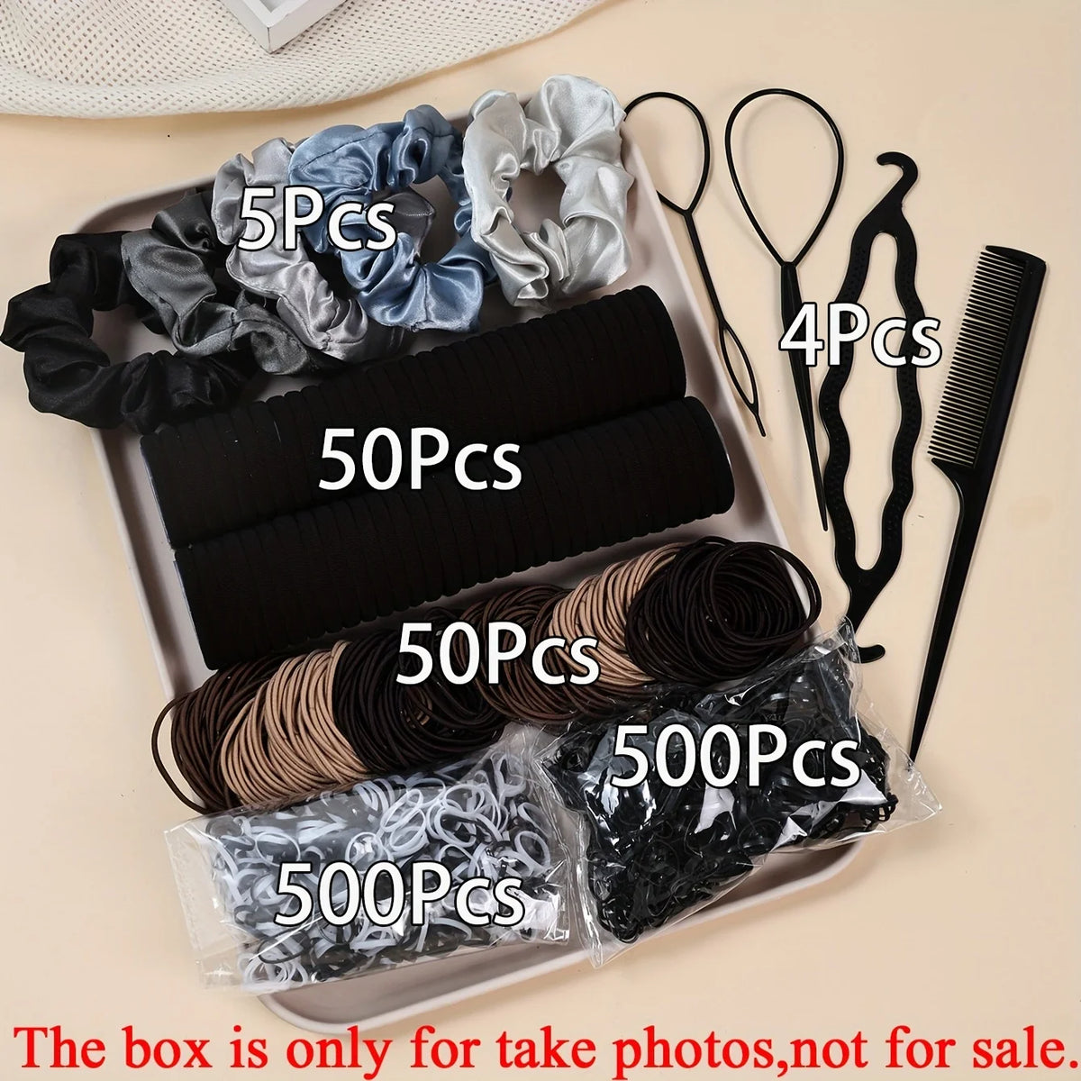 Un ensemble d'accessoires pour cheveux élastiques, y compris des élastiques, peignes et brosses noires et grises, emballés da