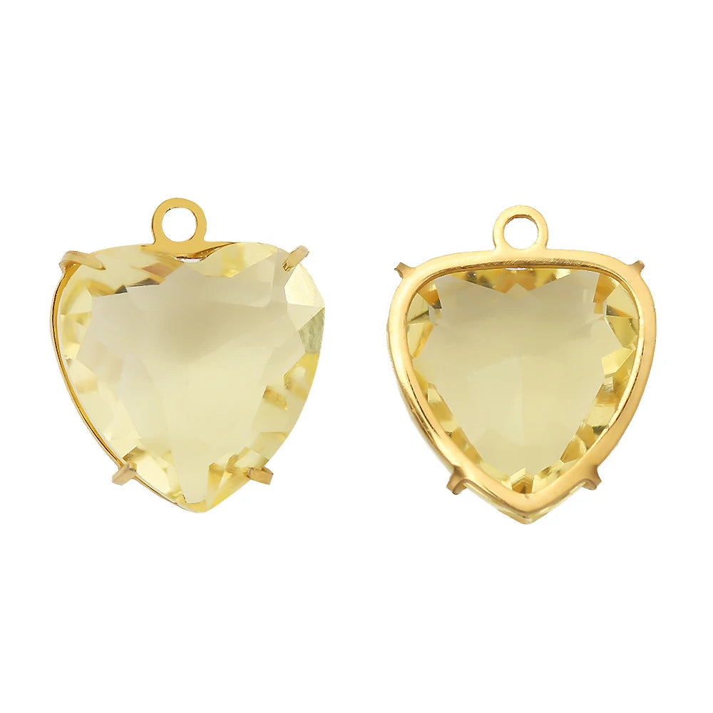 A pair of gold-toned heart crystal pendants with a yellow-tinted stone set in stainless steel.
