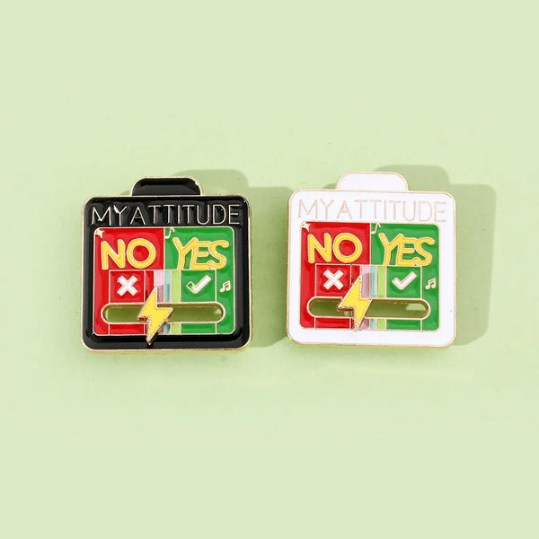 Two enamel brooch pins labeled NO YES featuring a lightning bolt symbol on a light green background.