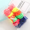 A bundle of colorful elastic hair ropes in pink, yellow, orange, green, and blue packaged for sale.