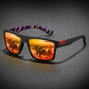 A pair of black vintage square sunglasses with an orange-tinted lens and a purple patterned temple.