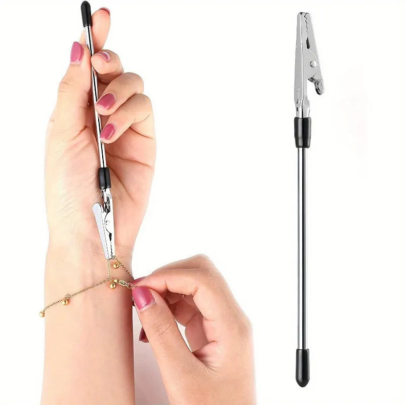 A hand holds a multi-purpose bracelet and joint repair tool with a metal clamp and needle.