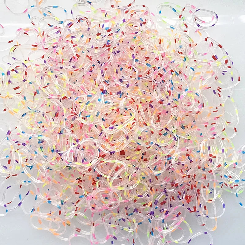 A pile of colorful disposable hair scrunchies in various shades of pink, purple, and clear.