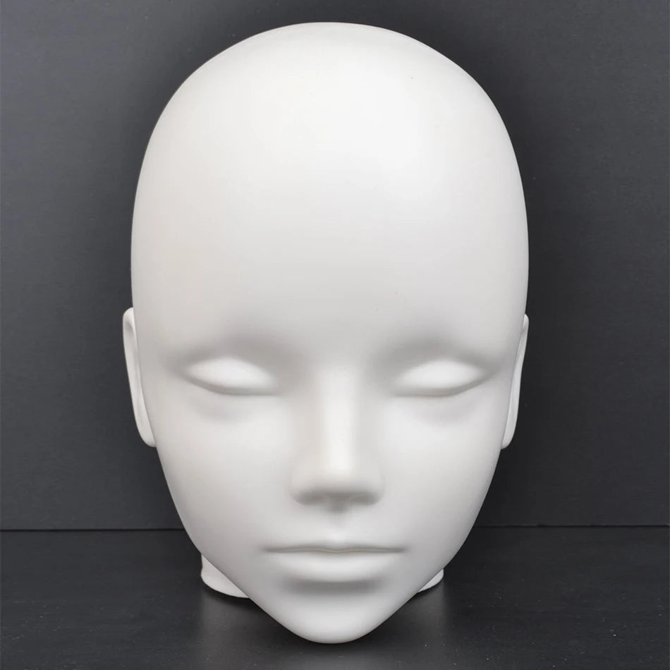 A white professional mannequin head used for practice and display.