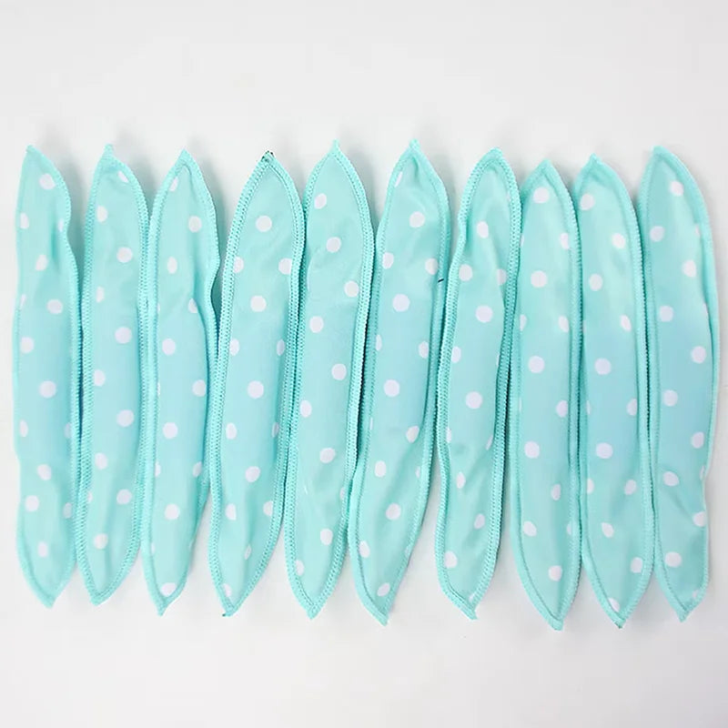 A set of ten flexible, light blue hair curling rollers with white polka dots arranged in a row.