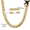 A close-up of a thick 14K gold-plated Miami Cuban chain necklace with a bail and a black airplane charm.