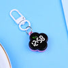A pink and black LED digital keychain watch with a silver clasp is displayed on a light blue background.