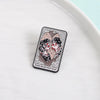 Broche émail noire avec une illustration stylisée de deux femmes avec des roses et le texte 'Things Are Better If I Stay'.