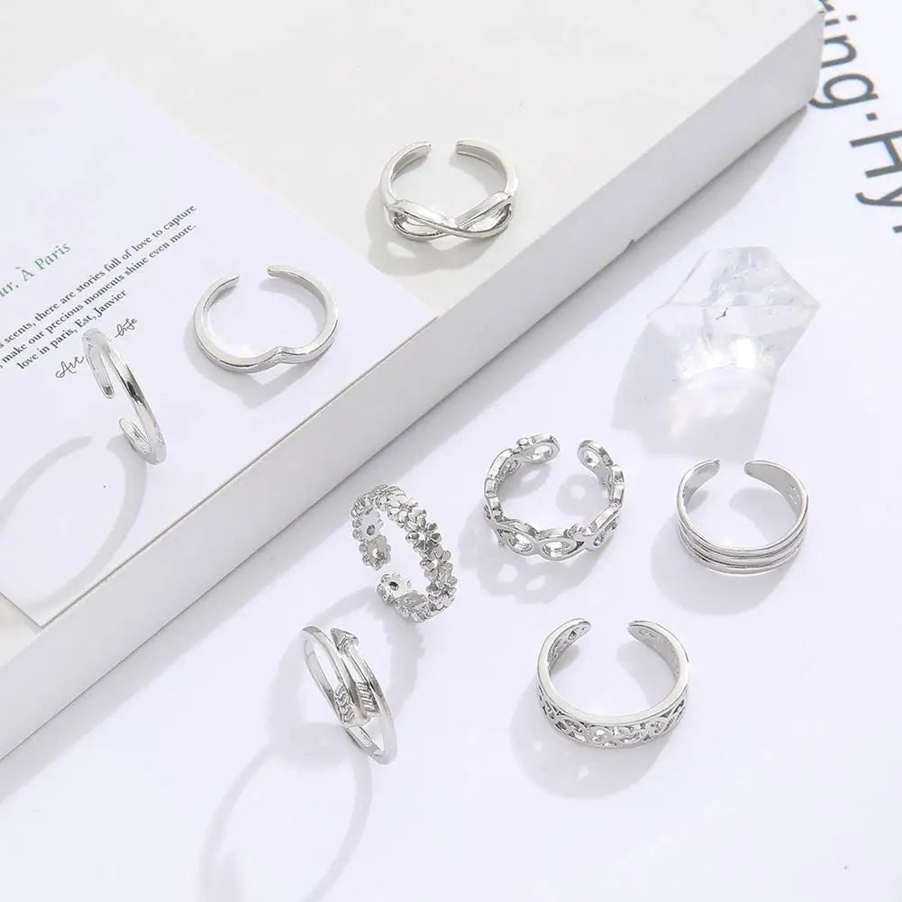 A set of silver adjustable open toe rings for women displayed on a white background.