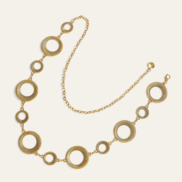 A delicate gold-toned hollow metal waist chain featuring multiple circular links.