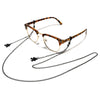 A pair of tortoiseshell-patterned glasses with a thin metal frame and a delicate chain necklace.