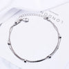 Sterling silver double heart charm bracelet displayed on a white background.