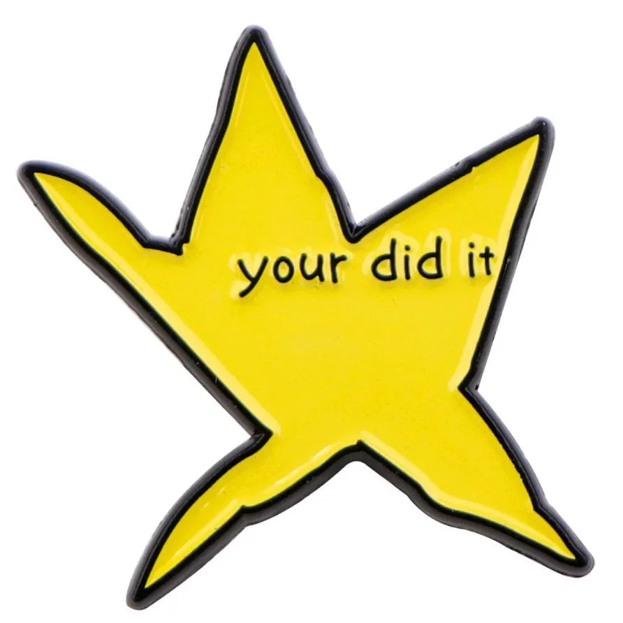 A yellow star shaped enamel pin with the text your did it on it.