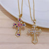 Gold vintage cross pendant necklace featuring colorful gemstone accents