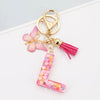 Alphabet letter acrylic keychain shaped like a letter with pink butterfly and pink tassel