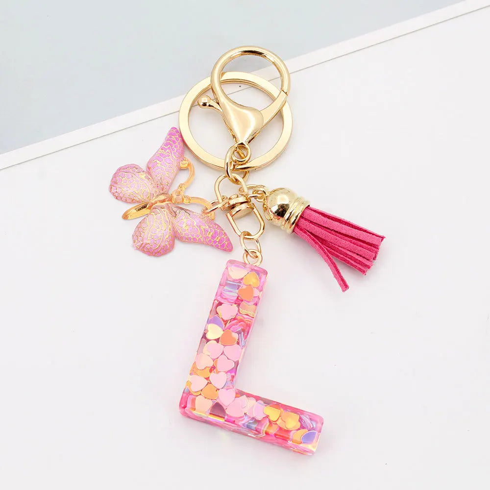 Alphabet letter acrylic keychain shaped like a letter with pink butterfly and pink tassel