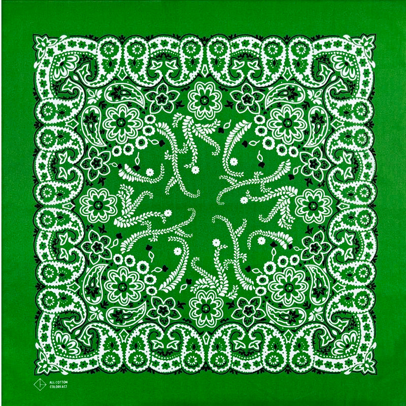 A green fabric with a white floral and vine pattern border and central design.