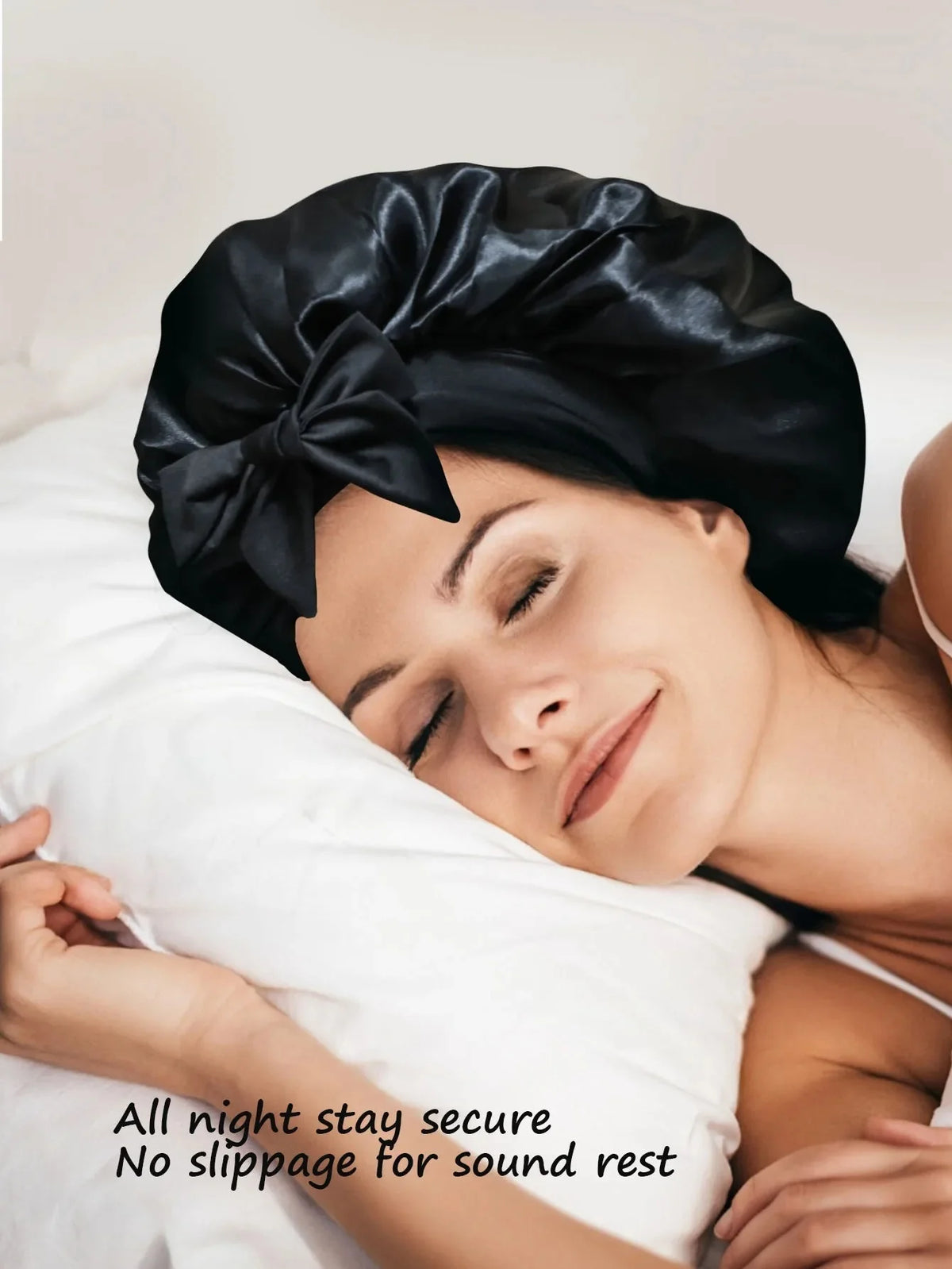 A woman is sleeping peacefully with a black satin wide-brimmed hair wrap headscarf on her head.