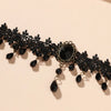 A black lace choker necklace featuring dark beads and a central black stone.