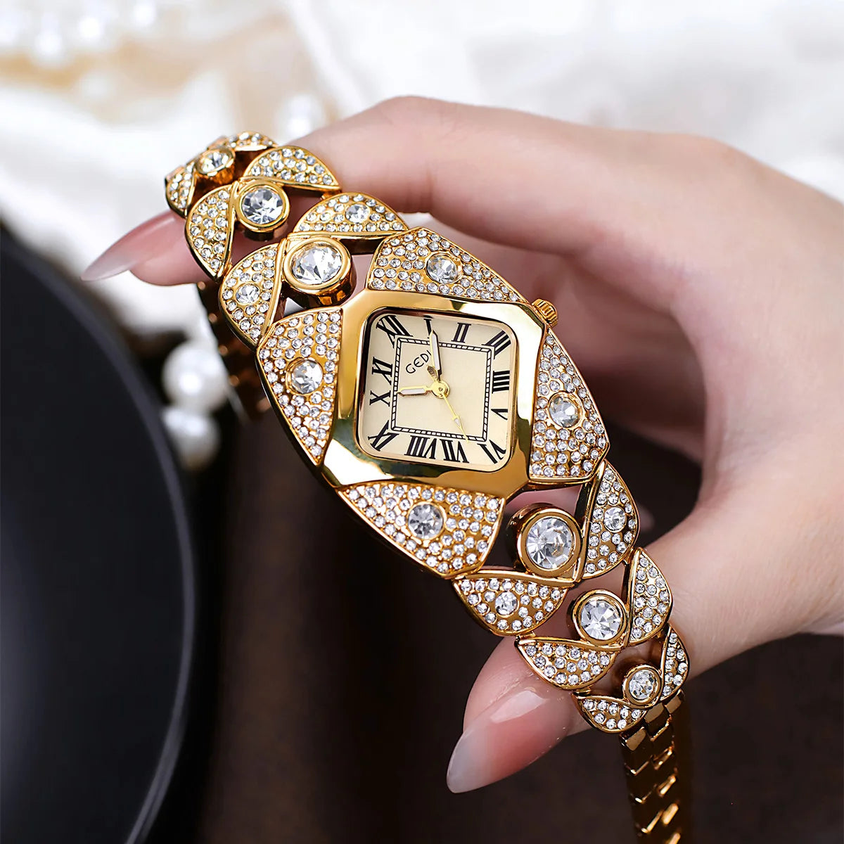 A hand holds a luxury diamond inlaid quartz wristwatch with gold casing and intricate diamond detailing.