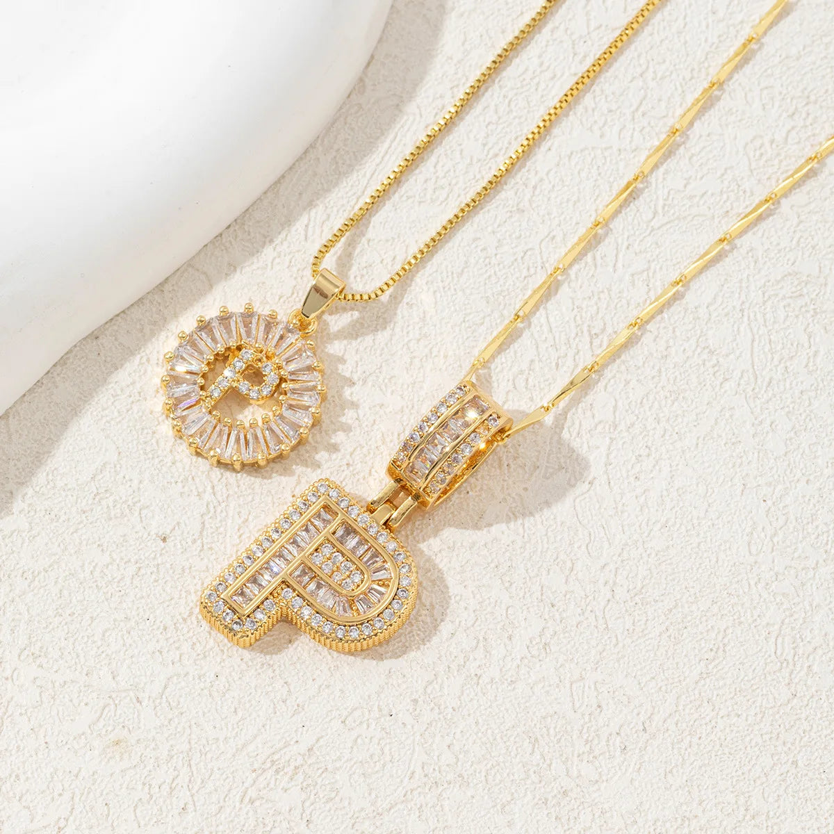 Gold-toned necklace set featuring CZ crystal pendants shaped like the letters I and D.