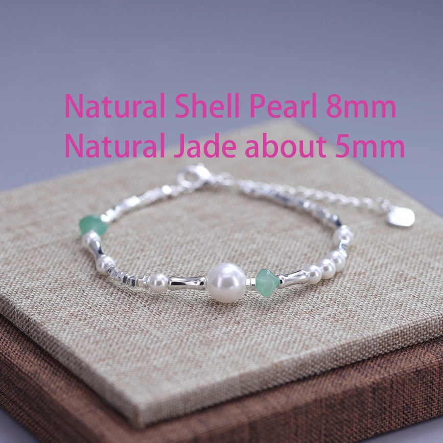 Sterling silver double heart charm bracelet featuring natural shell pearl and jade beads