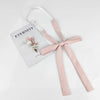 A pink ribbon tie set with a butterfly design is displayed on a white background.