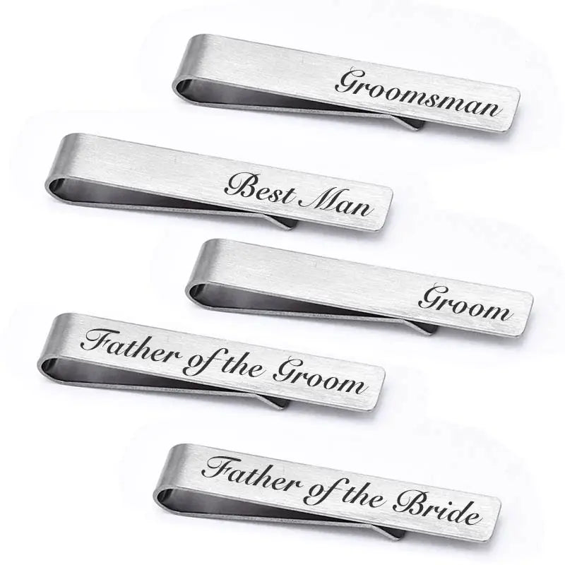 A set of four brushed stainless steel men's tie clips for groomsmen, best man, groom, and father of the bride.
