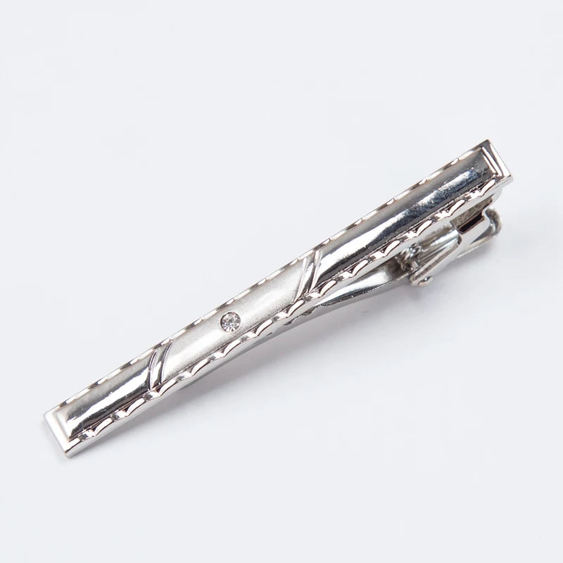 Silver metal tie clip for men's neckties with a decorative design.