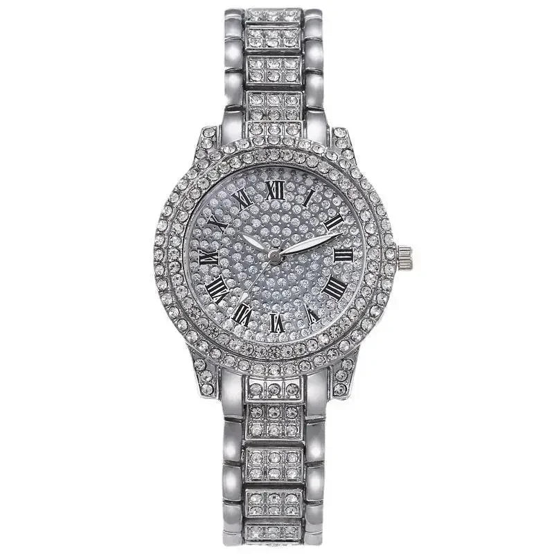 A silver-toned quartz wristwatch featuring a crystal bezel and a diamond-studded bracelet.