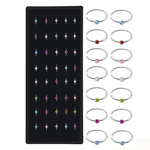 A set of fashion crystal stainless steel nose stud piercings in various sizes and styles.