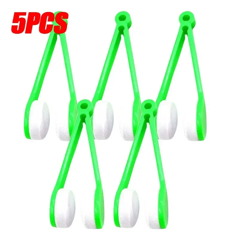 A set of five green plastic tools used for cleaning eyeglasses or similar items.