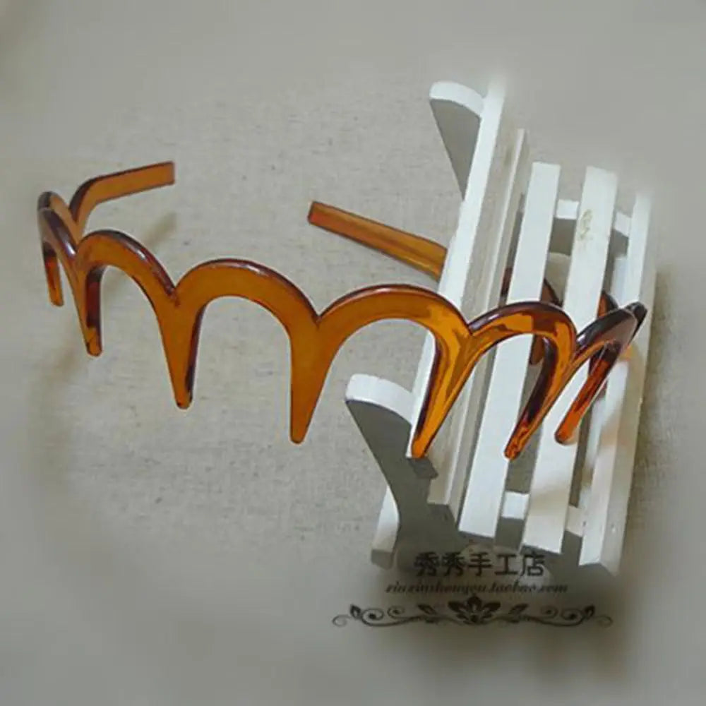A set of zigzag-shaped, amber-colored hair combs used for face concealment.