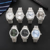 A collection of five luxury quartz men's wristwatches with metal bracelets and various dial colors displayed on a dark surfac