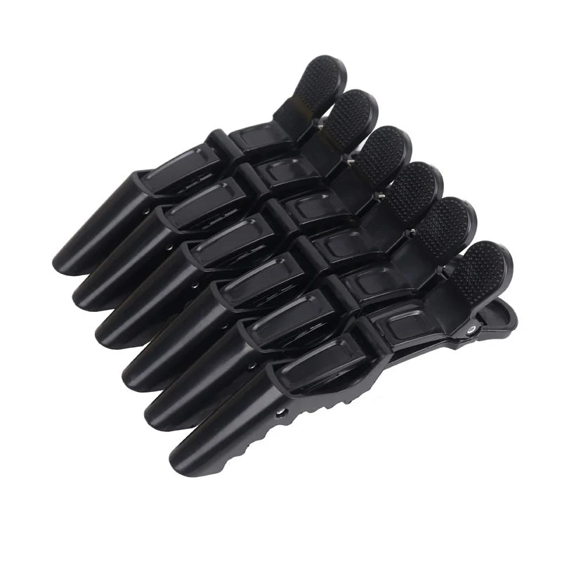 A set of six black alligator hair sectioning clips arranged in a fan shape.