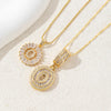 Gold-toned necklace set featuring CZ crystal pendants shaped like letters, displayed on a light background.