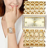 A close-up of a gold and diamond quartz watch with a stainless steel bracelet worn on a woman's wrist.