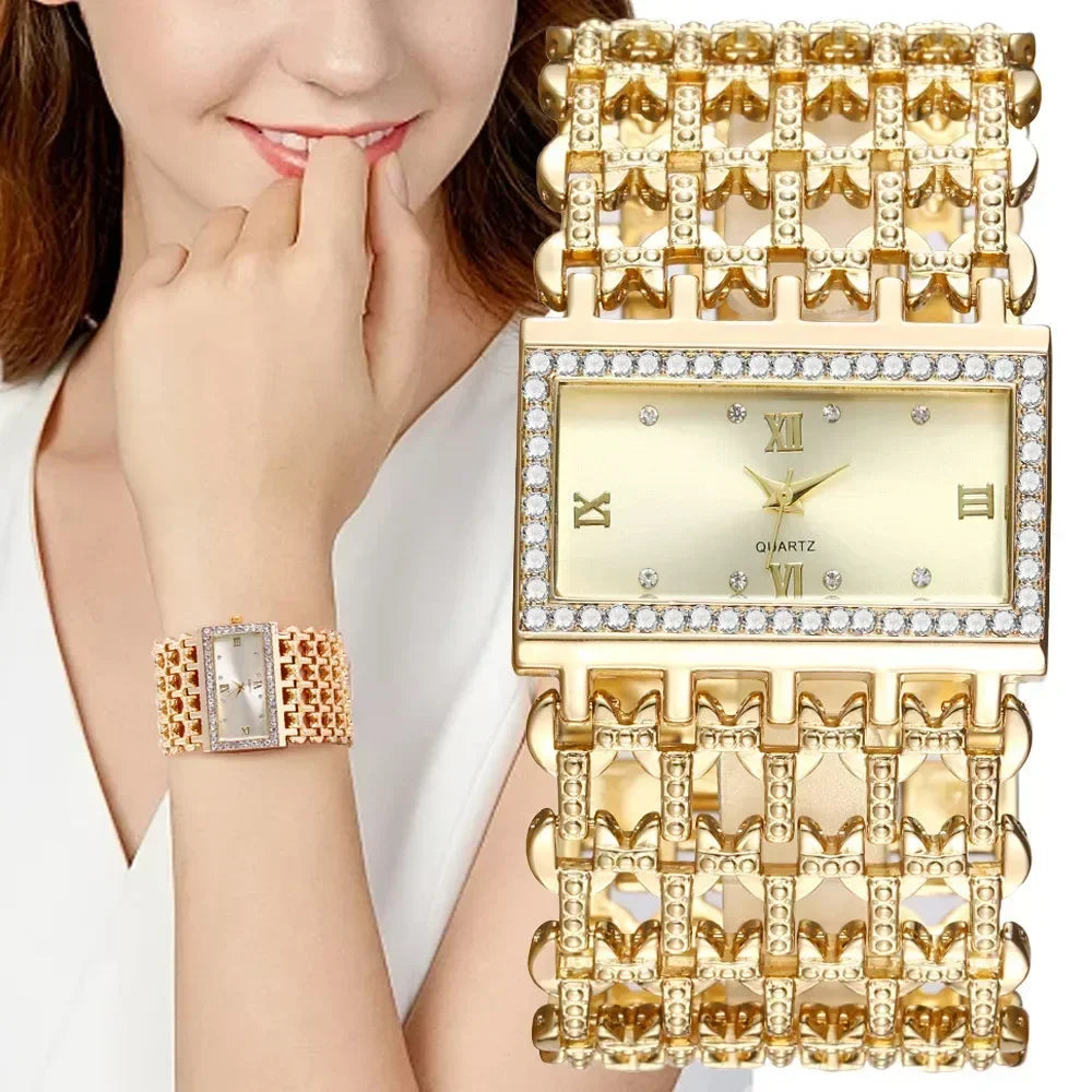 A close-up of a gold and diamond quartz watch with a stainless steel bracelet worn on a woman's wrist.