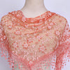 A sheer peach floral lace scarf draped around a mannequin's neck and shoulders.