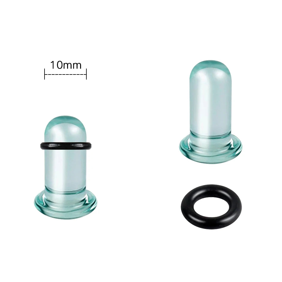 A clear glass ear stretching plug with a black ring and a measuring scale.