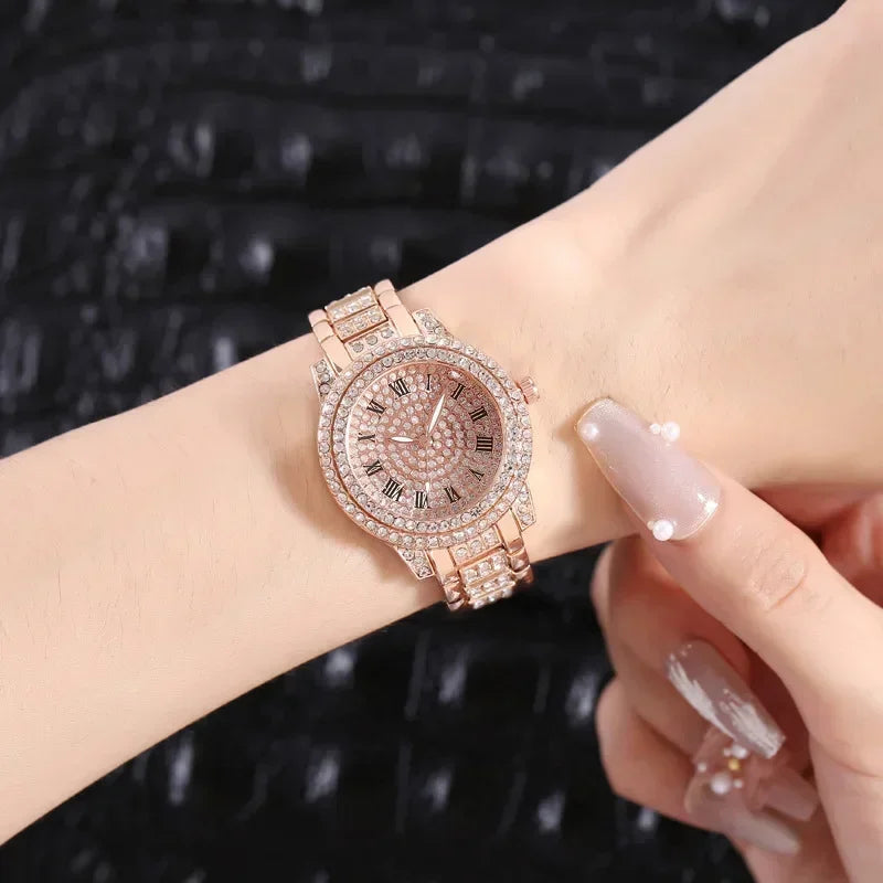 A close-up of an elegant rose gold rhinestone quartz wristwatch worn on a wrist.
