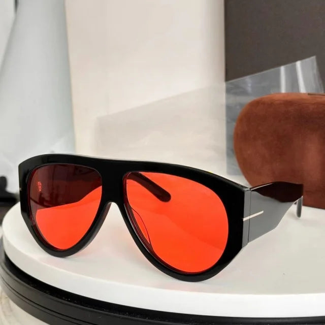 Oversized fashion pilot sunglasses with black frames and bright orange lenses displayed on a white surface.